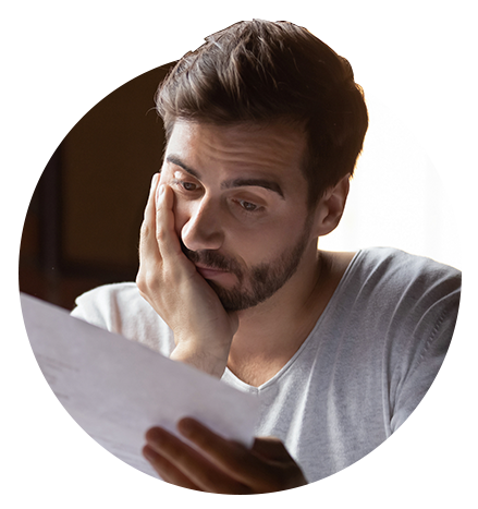 Business owner looking at paper documents concerned about looming recession - Circular image